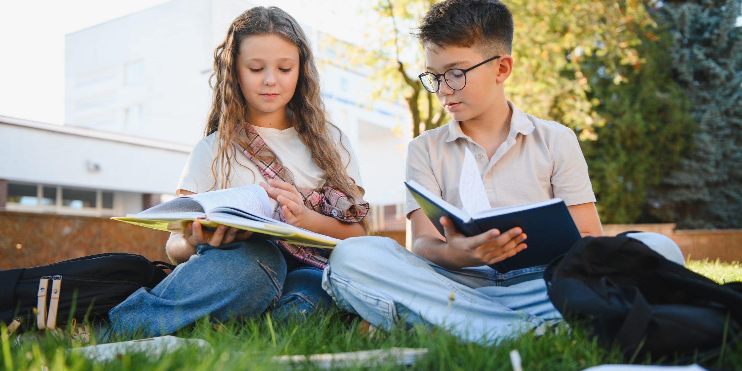 School,Children,Doing,Homework,And,Studying,Books,Outdoors,On,Campus.